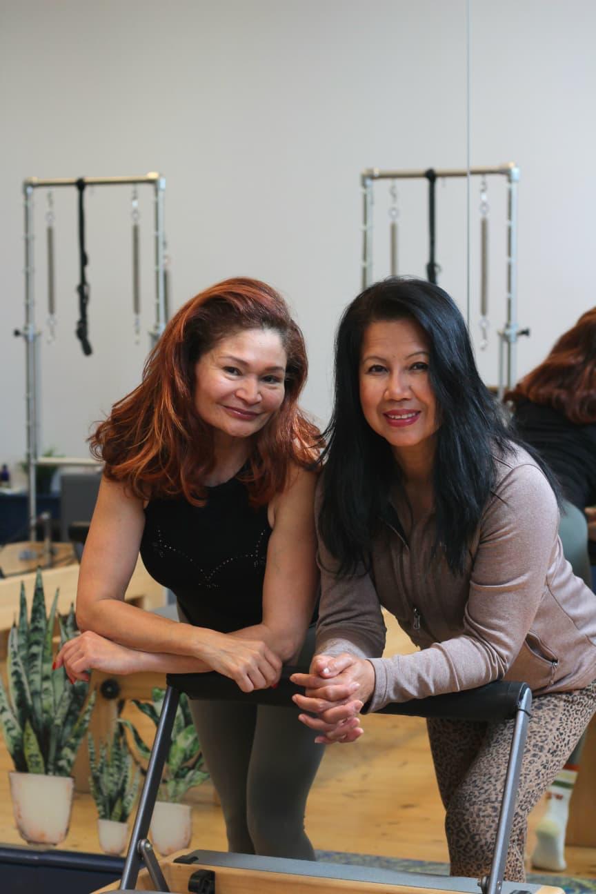 Rebecca and Kanya, Vida Pilates Studio instructors, in the reformer studio